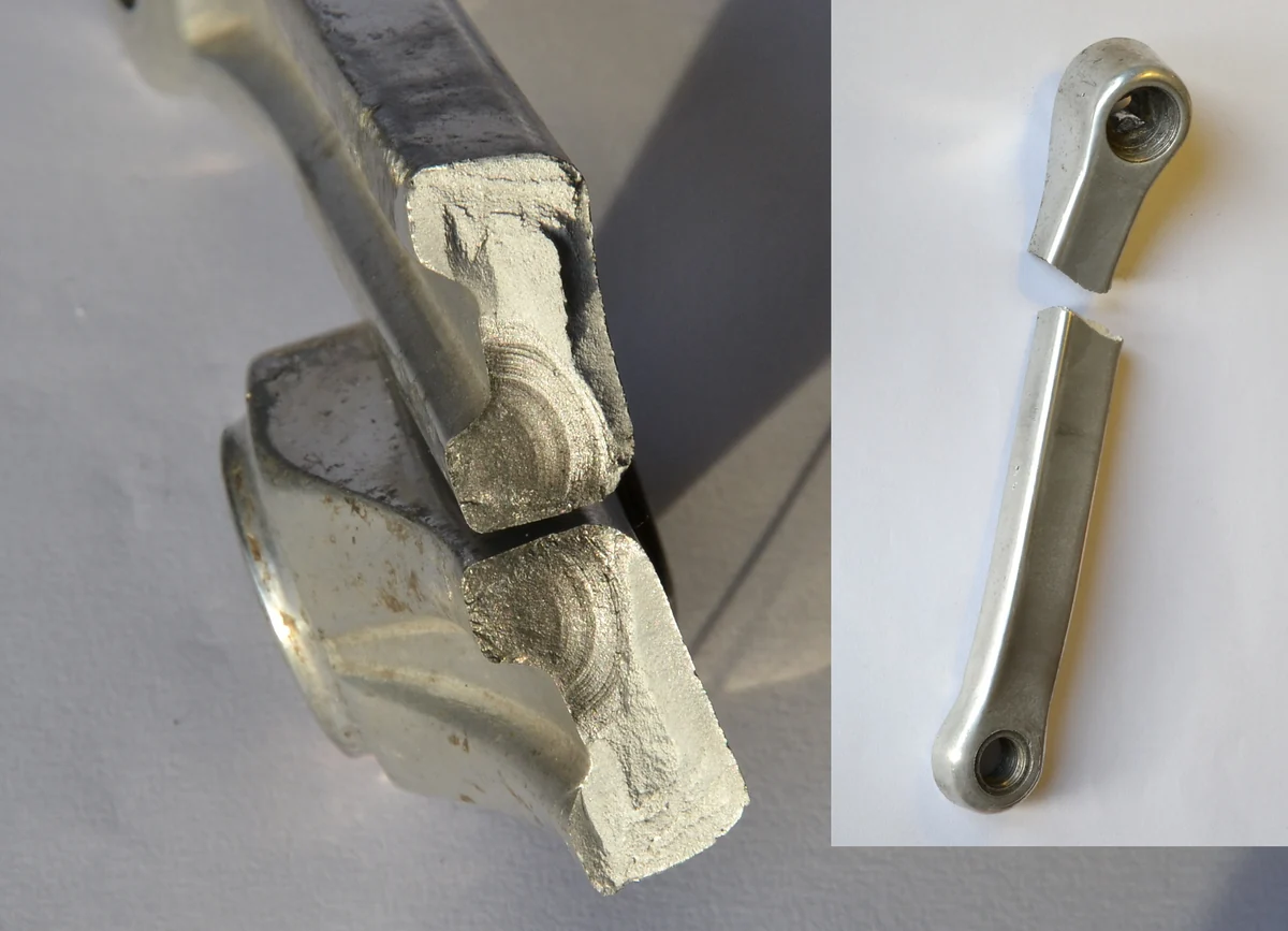 Photograph of a fractured bicycle crank arm and its two fracture faces